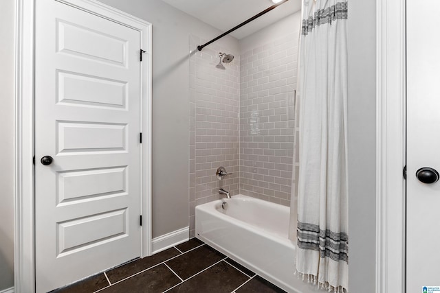 bathroom with baseboards, shower / bath combination with curtain, and tile patterned flooring