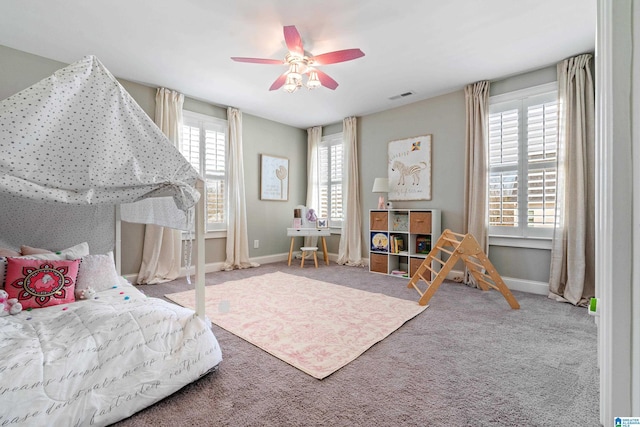 bedroom with visible vents, carpet flooring, a ceiling fan, and baseboards