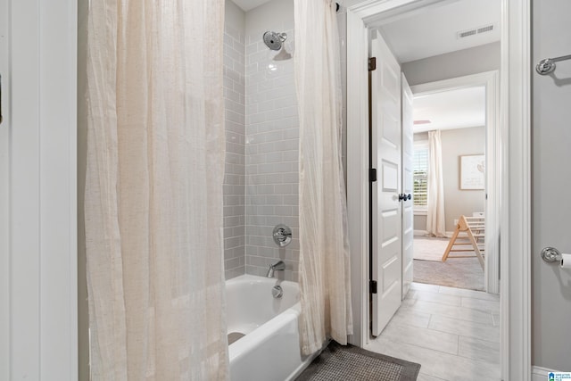 full bath with tile patterned floors, visible vents, and shower / bath combination with curtain