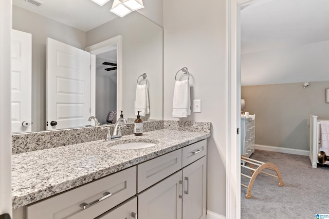 bathroom featuring visible vents, baseboards, and vanity