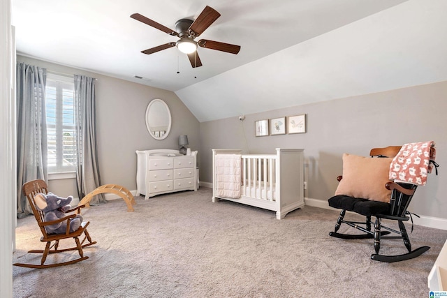 carpeted bedroom with lofted ceiling, a ceiling fan, baseboards, and visible vents