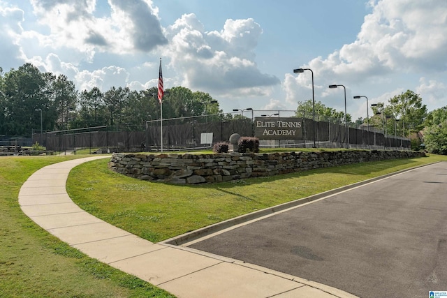 view of community with a yard and fence