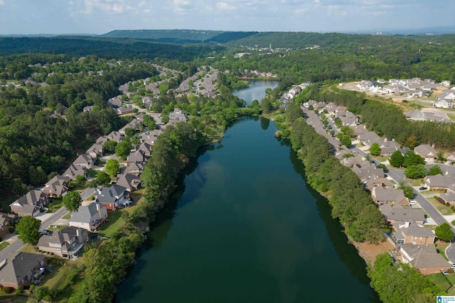 aerial view featuring a view of trees, a water view, and a residential view