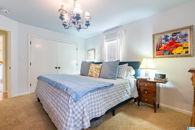 carpeted bedroom with a closet, baseboards, and a notable chandelier