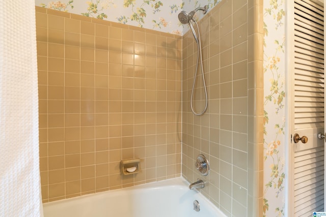 bathroom with wallpapered walls and shower / bathtub combination with curtain