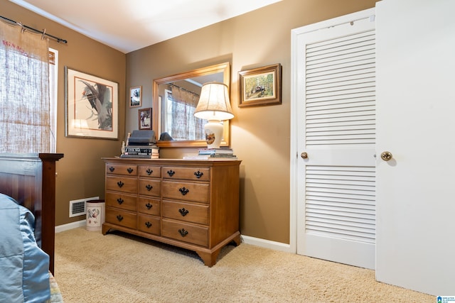 bedroom featuring baseboards, carpet floors, and visible vents