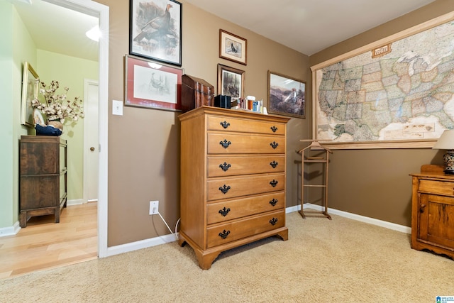 interior space with baseboards and light carpet