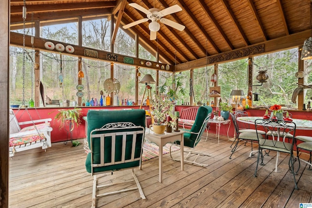 sunroom / solarium with wooden ceiling, lofted ceiling with beams, and a ceiling fan