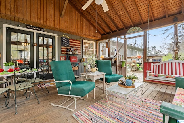 sunroom featuring lofted ceiling with beams, wooden ceiling, and a ceiling fan