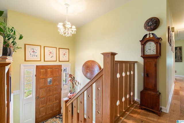 foyer entrance featuring tile patterned floors, baseboards, and a chandelier