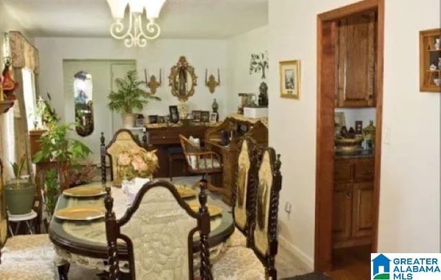 dining space with a notable chandelier and baseboards