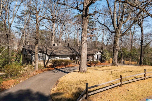 view of front of property with driveway and fence