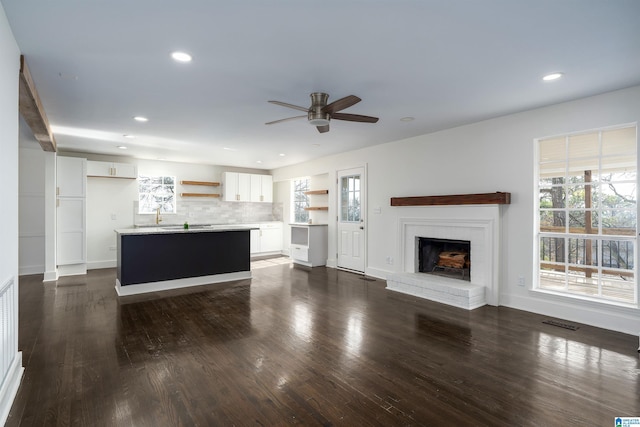 unfurnished living room featuring recessed lighting, visible vents, ceiling fan, and dark wood-style flooring