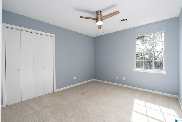 unfurnished bedroom with a closet, visible vents, baseboards, and carpet floors