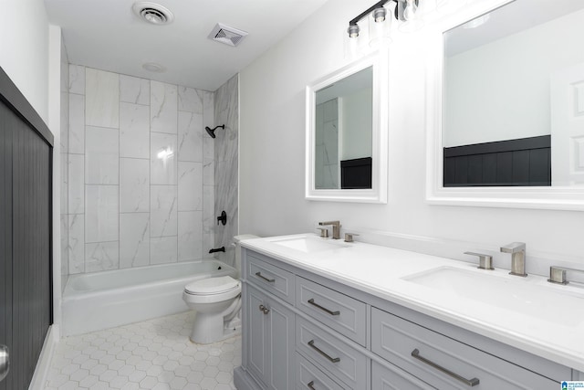 full bathroom with a sink, visible vents, toilet, and double vanity