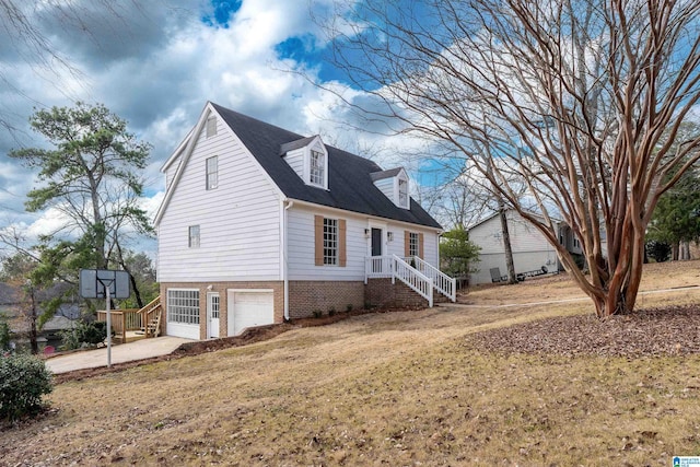 view of side of home with driveway and a garage