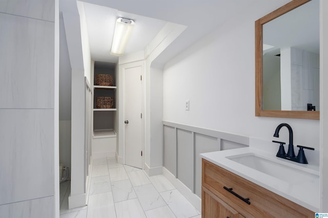 bathroom with marble finish floor and vanity