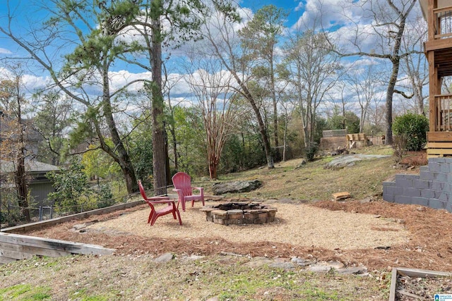 view of yard with an outdoor fire pit