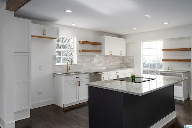 kitchen featuring dark wood finished floors, a sink, black electric stovetop, and open shelves