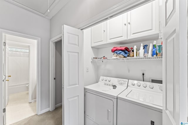 laundry room with cabinet space, attic access, separate washer and dryer, and baseboards