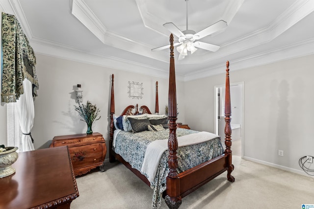 bedroom with a raised ceiling, a ceiling fan, carpet flooring, crown molding, and baseboards