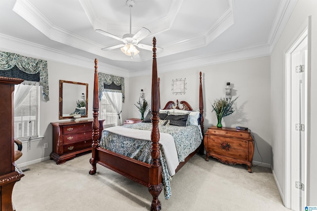 bedroom with a ceiling fan, a raised ceiling, carpet, and ornamental molding