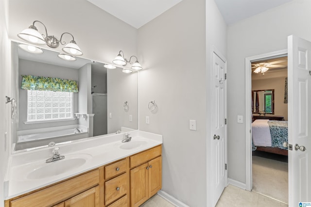 bathroom with ensuite bath, a garden tub, double vanity, and a sink