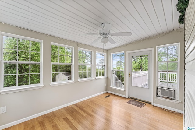 unfurnished sunroom with cooling unit and a ceiling fan