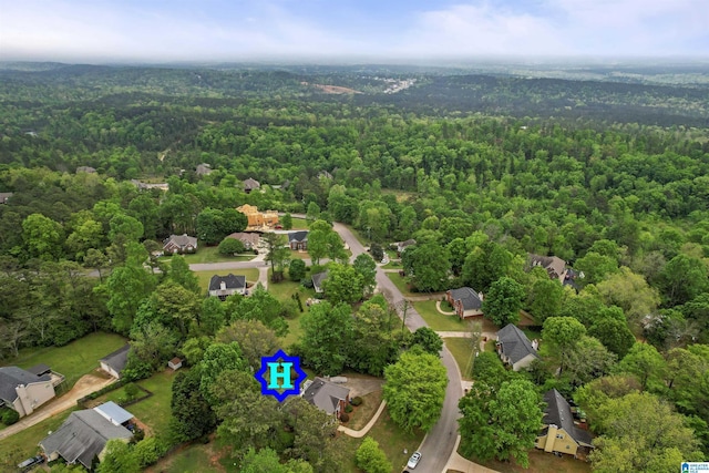 drone / aerial view with a wooded view