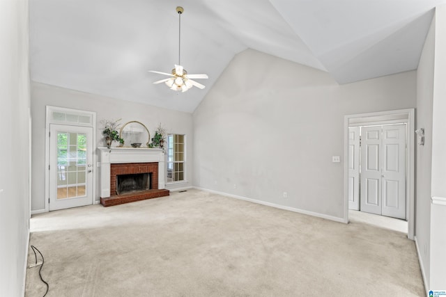 unfurnished living room with high vaulted ceiling, carpet floors, baseboards, a brick fireplace, and ceiling fan