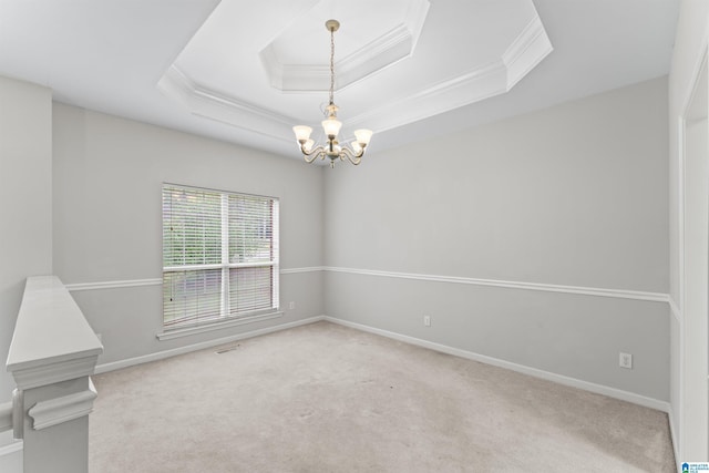 empty room featuring crown molding, baseboards, a tray ceiling, carpet floors, and a notable chandelier