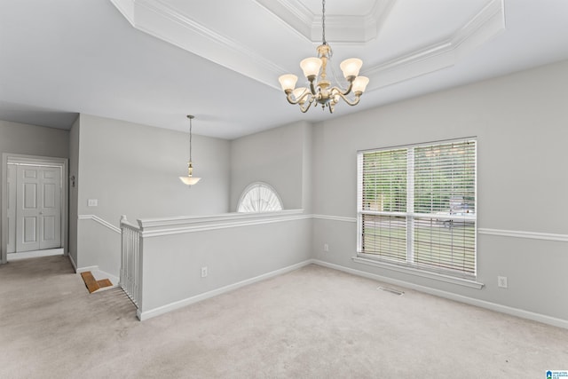 carpeted spare room featuring visible vents, crown molding, baseboards, a chandelier, and a tray ceiling