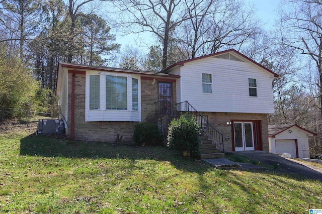 tri-level home with an outbuilding, fence, stairway, a front yard, and brick siding