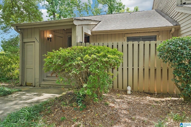 exterior space with roof with shingles and board and batten siding