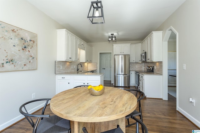 dining space featuring baseboards and dark wood-style flooring