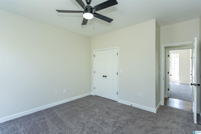 unfurnished bedroom with a closet, ceiling fan, baseboards, and carpet floors