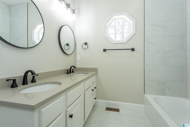 bathroom with visible vents, marble finish floor, baseboards, and a sink