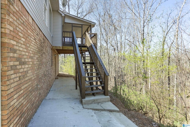 exterior space featuring brick siding and a deck