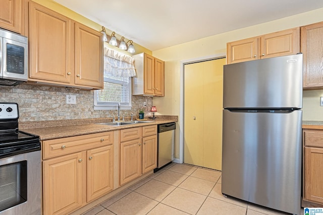 kitchen with light tile patterned flooring, a sink, light brown cabinetry, stainless steel appliances, and backsplash