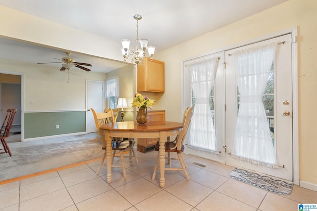 dining space featuring light tile patterned floors, visible vents, light colored carpet, and baseboards