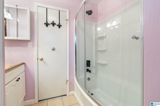 bathroom with tile patterned flooring, vanity, and bath / shower combo with glass door