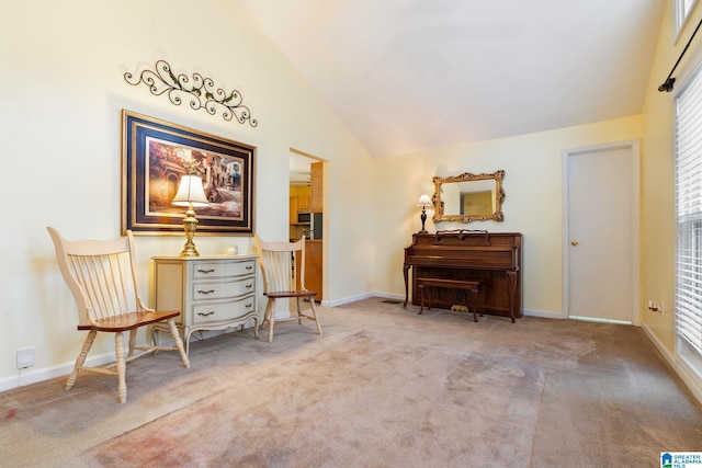 living area featuring high vaulted ceiling, baseboards, and carpet