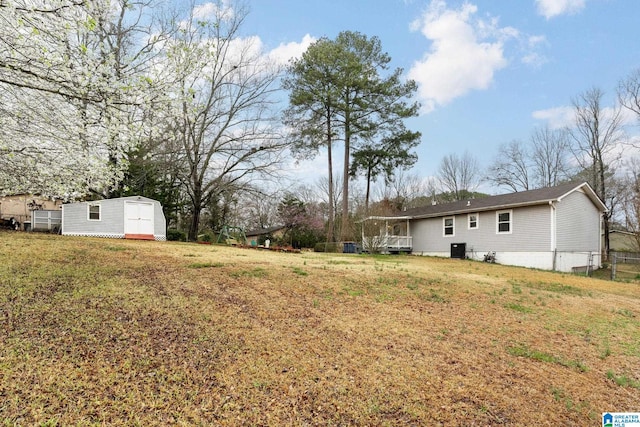 view of yard with a storage shed and an outbuilding