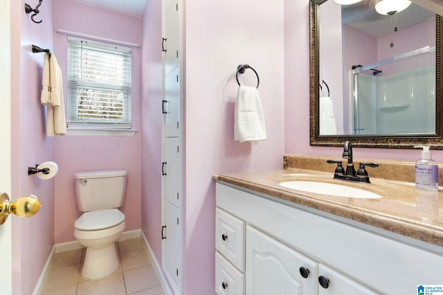 bathroom with vanity, baseboards, tile patterned flooring, toilet, and a shower with door