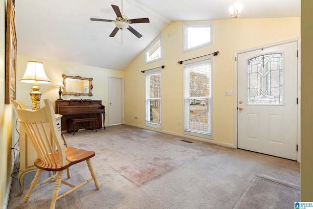 carpeted foyer featuring ceiling fan, baseboards, visible vents, and high vaulted ceiling