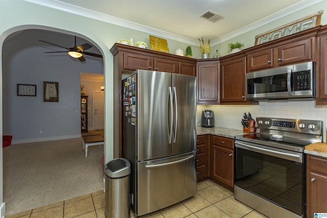 kitchen featuring ornamental molding, light colored carpet, visible vents, and stainless steel appliances