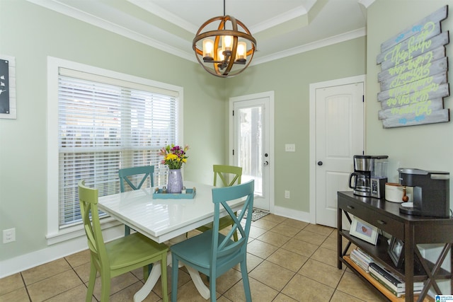 dining room with light tile patterned floors, a notable chandelier, a raised ceiling, and ornamental molding