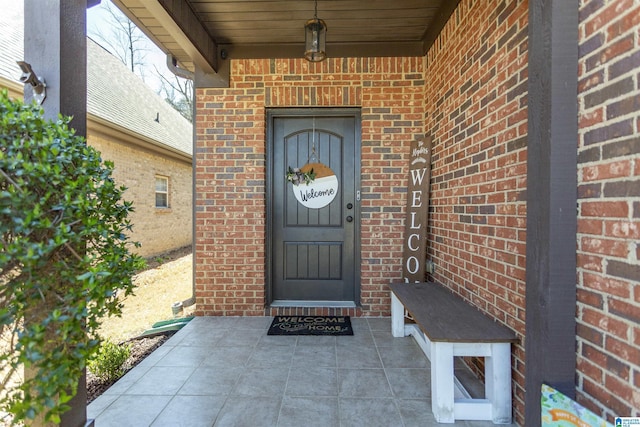 view of exterior entry with brick siding