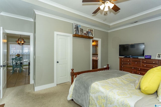 bedroom with visible vents, baseboards, crown molding, light colored carpet, and connected bathroom