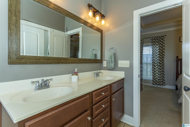 full bathroom featuring double vanity, baseboards, and a sink